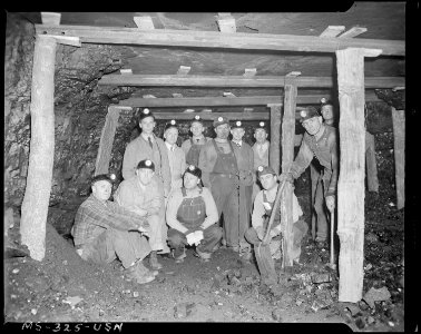Medical survey inspection party and miners at working face of mine. This is two miles from opening. Temporary... - NARA - 540357
