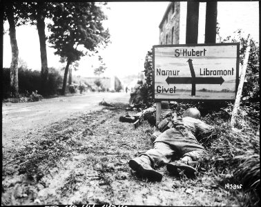 Men of the 8th Infantry Regiment attempt to move forward and are pinned down by German small arms from within the... - NARA - 531212