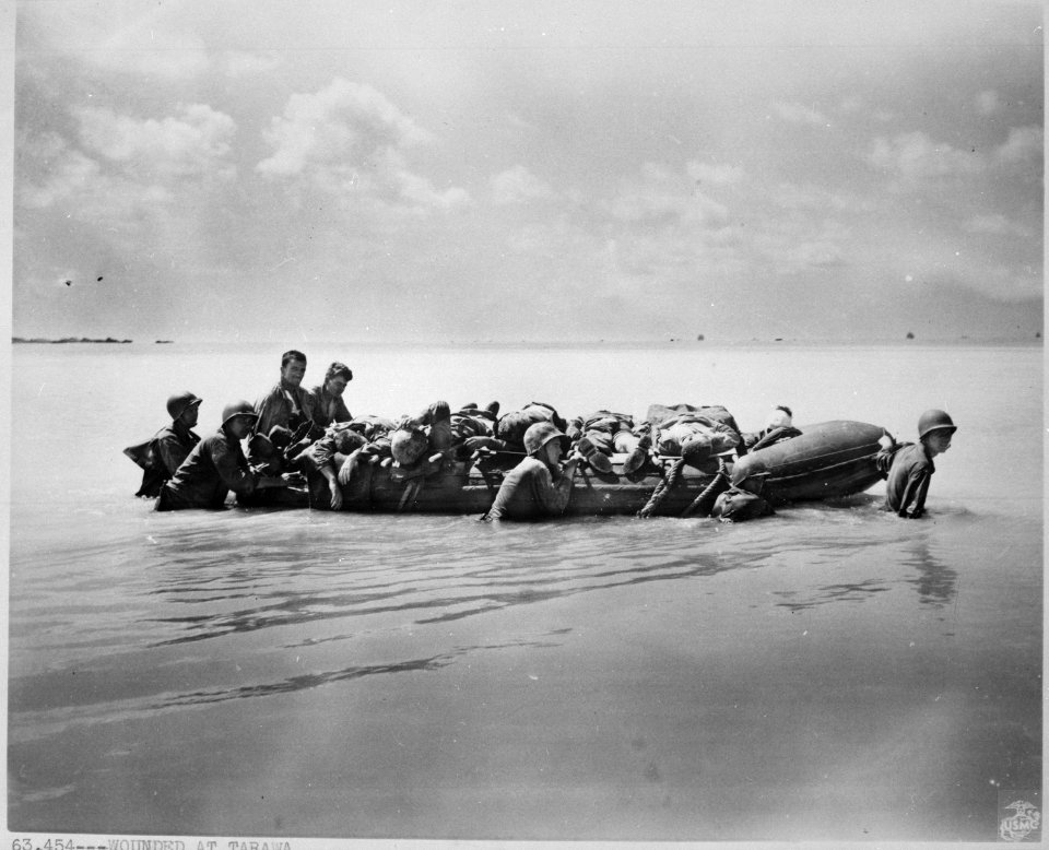 Marines wounded during the landing on Tarawa are towed out on rubber boats by their buddies to larger vessels that... - NARA - 532360
