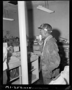 Miner eating ice cream cone in company owned store. Pittsburgh Coal Company, Westland Mine, Westland, Washington... - NARA - 540332