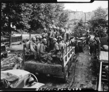 Men of the 24th Infantry Regiment move up to the firing line in Korea. - NARA - 531362 photo