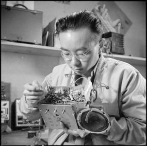 Minidoka Relocation Center, Minidoka, Washington. Radio repair shop. Henry Tambora, radio repairman. - NARA - 536540