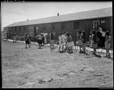Minidoka Relocation Center, Hunt, Idaho. Hunt High School students clean and rake areas between cla . . . - NARA - 539492