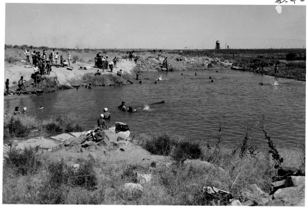 Minidoka Relocation Center, Hunt, Idaho. Swimming hole located south of warehouse is adjacent to th . . . - NARA - 539487
