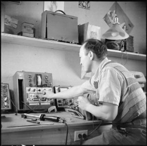 Minidoka Relocation Center, Minidoka, Washington. Radio Repair shop. Chester Sekura, radio repairman. - NARA - 536539