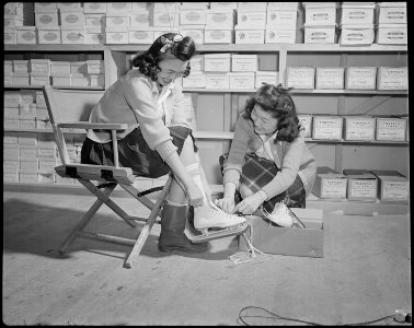 Minidoka Relocation Center. Betty Yasunobu, Nellie Arai, salesgirl. Selling skates in Community st . . . - NARA - 536574