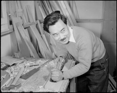 Minidoka Relocation Center. Geo. Nakashima. Constructing and decorating model apartment to show p . . . - NARA - 536582 photo