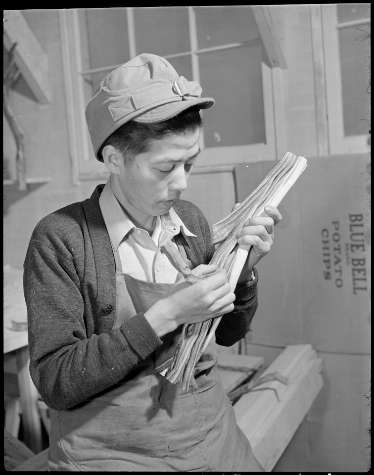 Minidoka Relocation Center. G. Kenneth Hikogawa. Polishing grease-wood to make furniture. - NARA - 536584