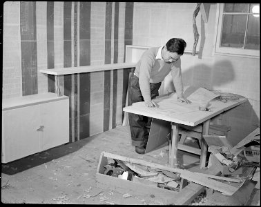 Minidoka Relocation Center. Geo. Nakahima. Constructing and decorating model apartment to show po . . . - NARA - 536581
