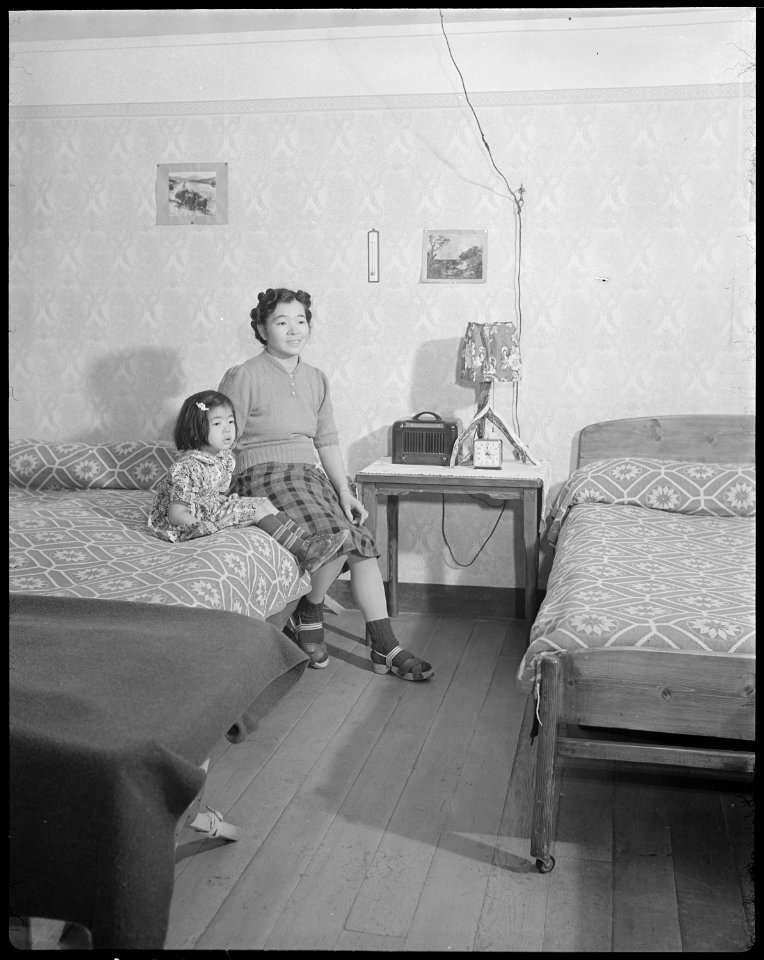 Minidoka Relocation Center. Mrs. Eizo Nishi, and Eime, four, daughter. All the furniture in this e . . . - NARA - 536579