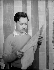 Minidoka Relocation Center. Geo. Nakashima. Constructing and decorating model apartment to show p . . . - NARA - 536583 photo