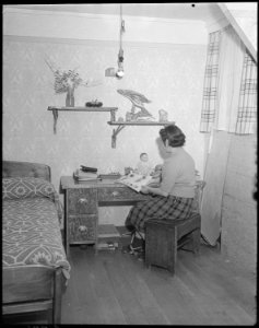 Minidoka Relocation Center. Mrs. Eizo Nishi. All the furniture in this evacuee apartment was const . . . - NARA - 536580 photo