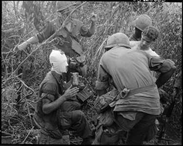Members of Company D ist Battalion, 501st Airborne Infantry relate battle and wounds received during action east of... - NARA - 531455 photo