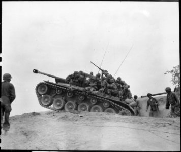 Men of the 9th Infantry Regiment man an M-26 tank to await an enemy attempt to cross the Naktong River. - NARA - 531372