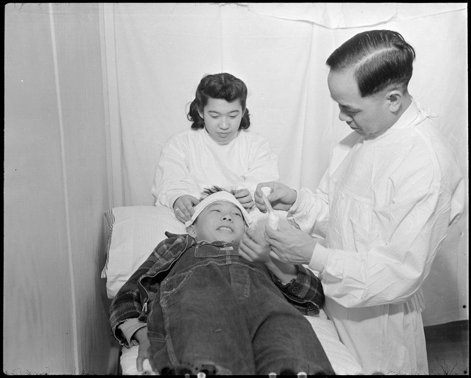 Minidoka Relocation Center. Doctor Robert H. Shiomi, Miyoko Shitamae, nurse, Jimmie Shimizu, patien . . . - NARA - 536596