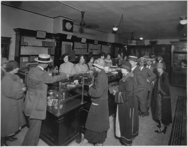Mrs. Snyders Candy Shop. Showing customers standing at counter behind which sales girls are shown. - NARA - 522874