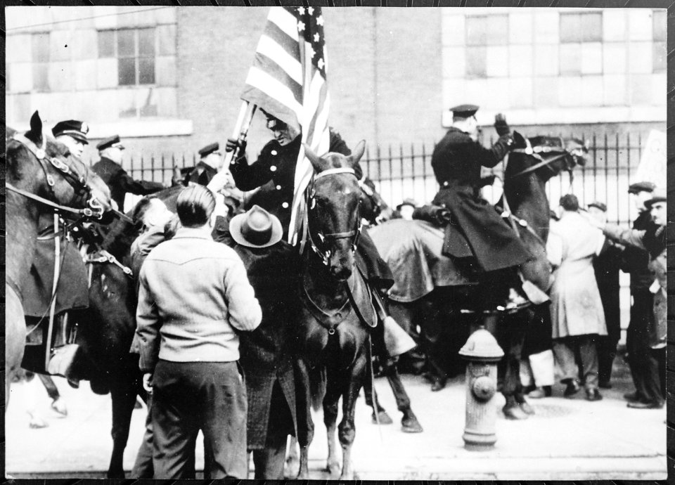 Mounted police clashing with strikers, one carrying an American flag, outside an electrical plant in Philadelphia, 1946 - NARA - 541924