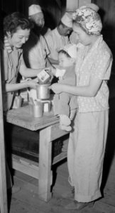 Mother and child on April 2, 1942 detail, Manzanar Relocation Center, Manzanar, California. Special food formula are prepared for babies at M . . . - NARA - 536756 (cropped)