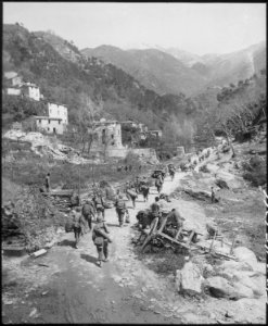 Moving up through Prato, Italy, men of the 370th Infantry Regiment have yet to climb the mountain which lies ahead. - NARA - 531277