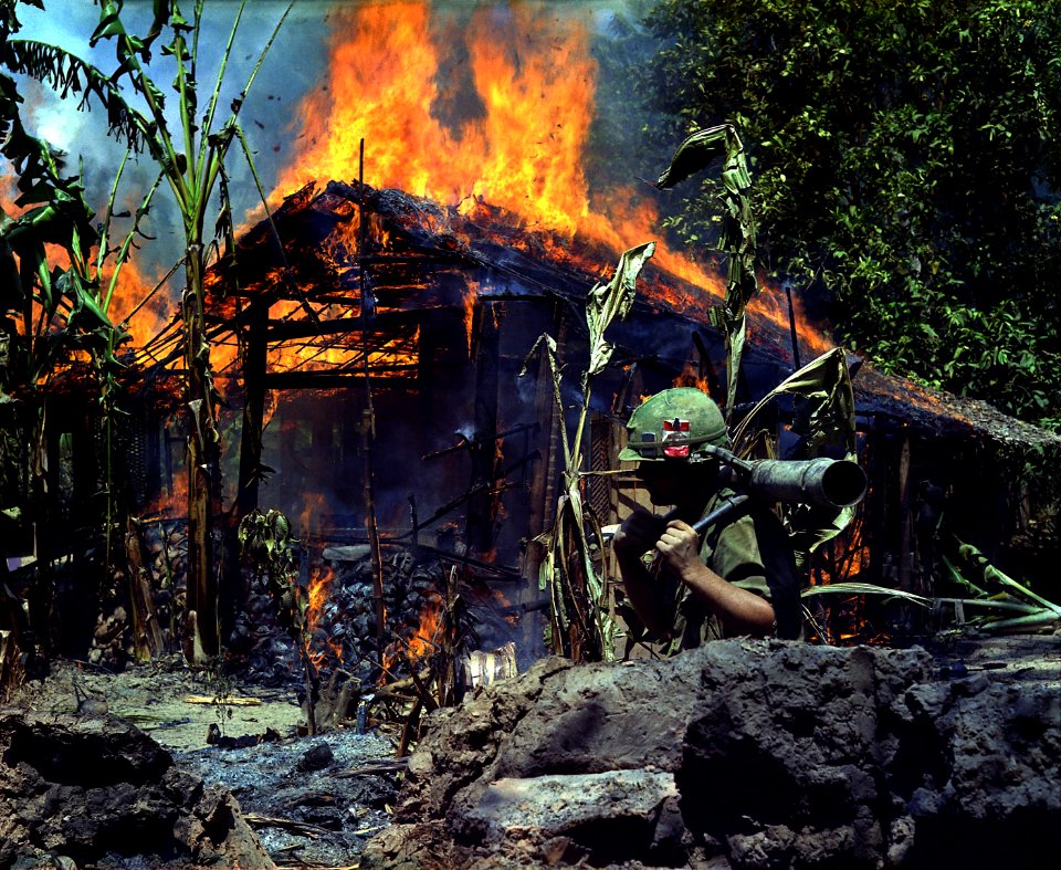 My Tho, Vietnam. A Viet Cong base camp being. In the foreground is Private First Class Raymond Rumpa, St Paul, Minnesota - NARA - 530621 edit