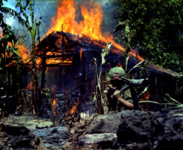 My Tho, Vietnam. A Viet Cong base camp being. In the foreground is Private First Class Raymond Rumpa, St Paul, Minnesota - NARA - 530621 edit