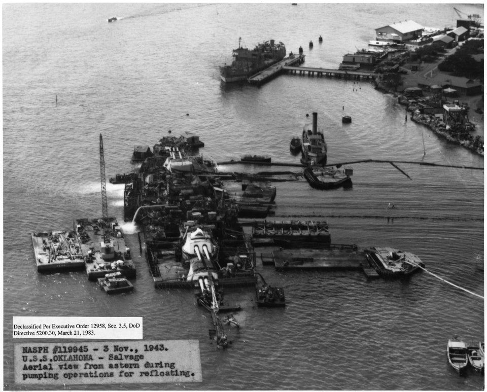 NASPH ^119945- 3 Nov 1943. USS Oklahoma- Salvage, Aerial view from astern during pumping operations for refloating - NARA - 296955