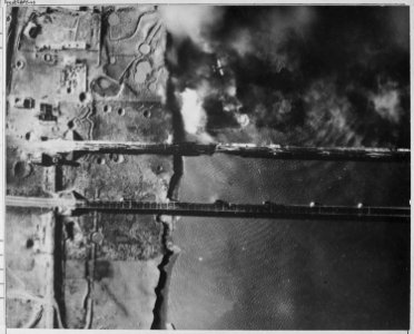 Navy AD-3 dive bomber pulls out of dive after dropping a 2000 pound bomb on Korean side of a bridge crossing the Yalu... - NARA - 520776 photo