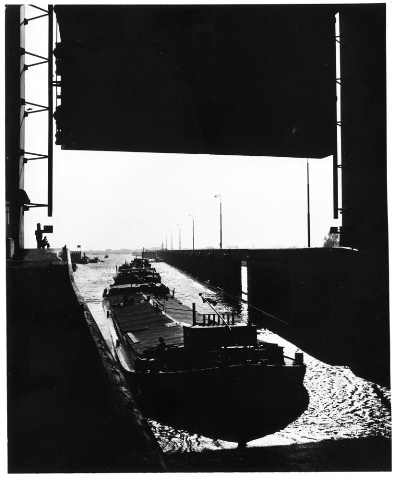 Netherlands. After World War II, a string of barges passes through the lockgates of the Princess Beatrix sluice at... - NARA - 541715
