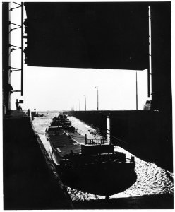 Netherlands. After World War II, a string of barges passes through the lockgates of the Princess Beatrix sluice at... - NARA - 541715
