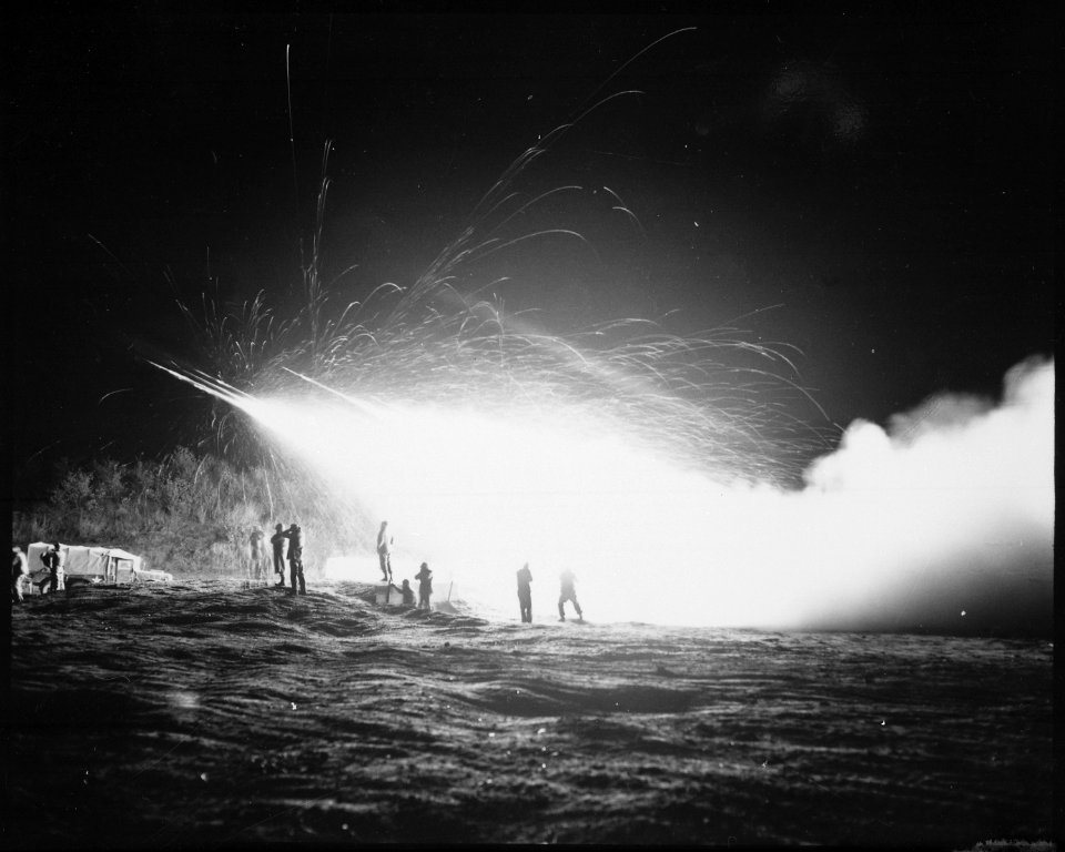 Night view of the First Rocket Battery, 11th Marine Regiment, firing a night mission, somewhere in the Marines front... - NARA - 532427