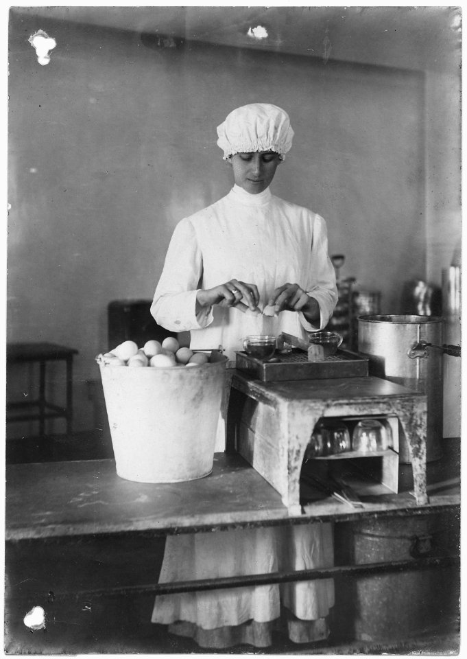 No original caption. (Women worker testing eggs.) - NARA - 532623 photo