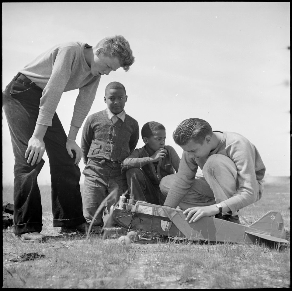 Oakland, California. High School Youth. Two Negro youngsters look over the shoulders of a couple of fortunate enough... - NARA - 532226