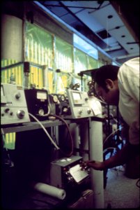 OLIN MOSS, INSTRUMENT TECHNICIAN ON AIR SANITATION CALIBRATING HYDROCARBON ANALYZERS. SMOG - NARA - 542765 photo