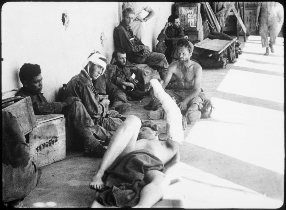 On the porch of an emergency hospital these released American prisoners of war, liberated by U.S. Rangers from... - NARA - 531251