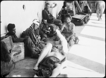 On the porch of an emergency hospital these released American prisoners of war, liberated by U.S. Rangers from... - NARA - 531251