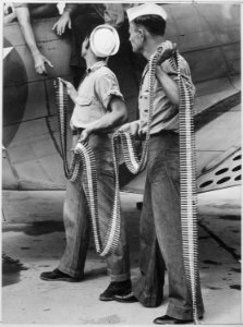 Ordnancemen loading belted cartridges into SBD-3 at Naval Air Station in Norfolk, Virginia - NARA - 520918