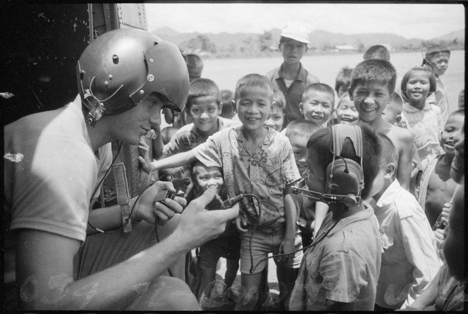 Para-rescue technician talks to Thai children who were attracted by the helicopter's landing. - NARA - 542313