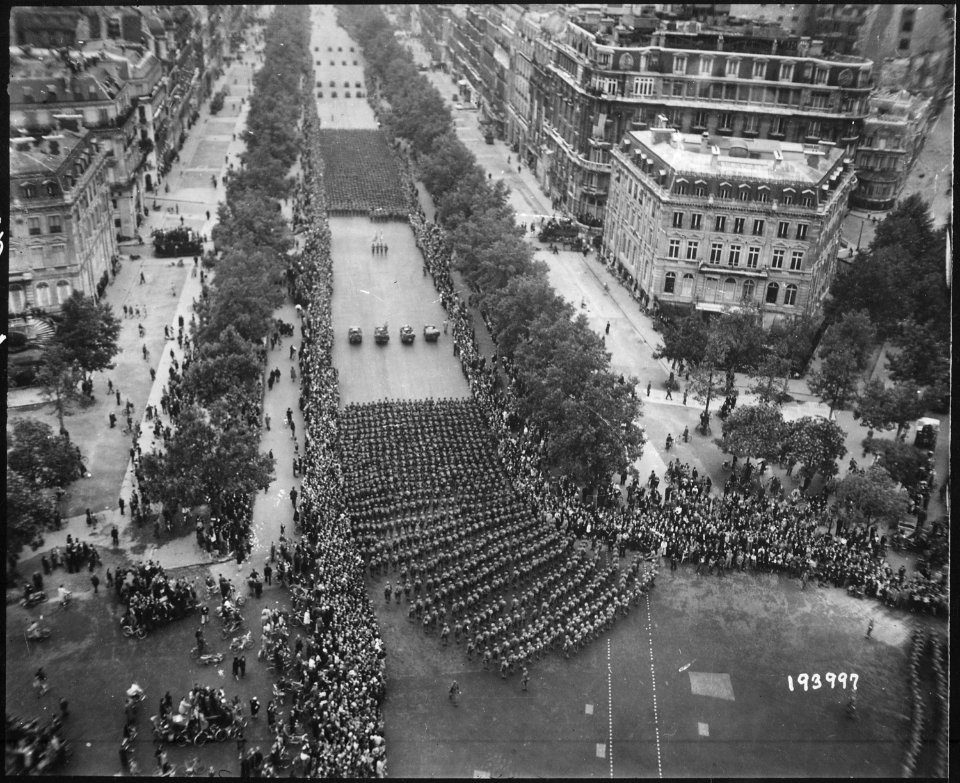 Parisians line the Champs Elysees to cheer the massed infantry units of the American army as they march in review... - NARA - 531215