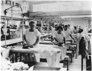 Older women doing hand ironing in laundry where general lay-out is good, but women apparently have no seats. Sitting... - NARA - 522869 photo