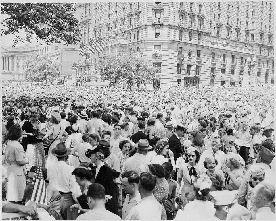 Photograph of a large crowd gathered outside the Willard Hotel in Washington to welcome General Dwight D. Eisenhower. - NARA - 199115