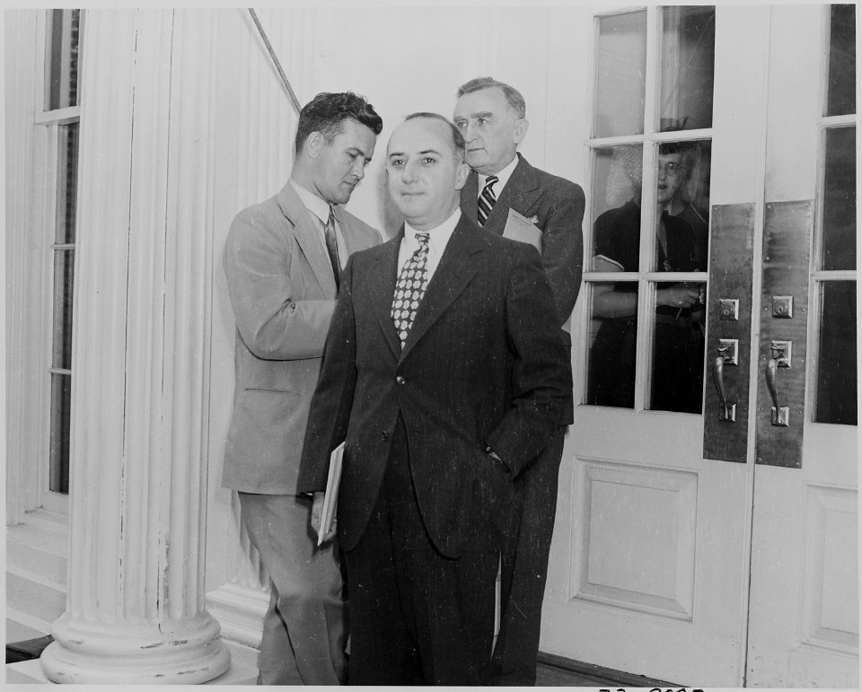 Photograph of a reporter and two unidentified men outside the White House on the occasion of the announcement of the... - NARA - 199160