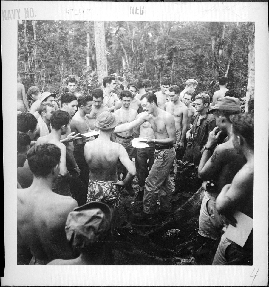 Personnel of VB104 & VB106 gather around Chief Yeoman Willis to receive their mail on Munda, New Georgia Island. - NARA - 520909