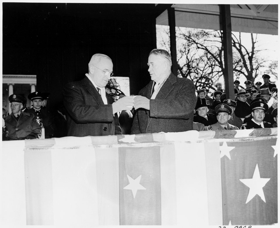 Photograph of an armored vehicle passing the reviewing stand during the Inaugural parade, as President Truman and... - NARA - 200063