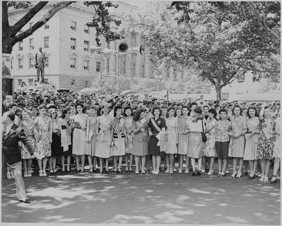 Photograph of a group of young women, identified as War Bond Commandos, gathered along a Washington street to... - NARA - 199110