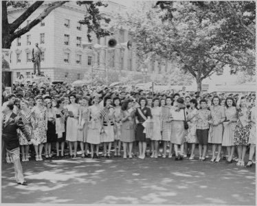 Photograph of a group of young women, identified as War Bond Commandos, gathered along a Washington street to... - NARA - 199110