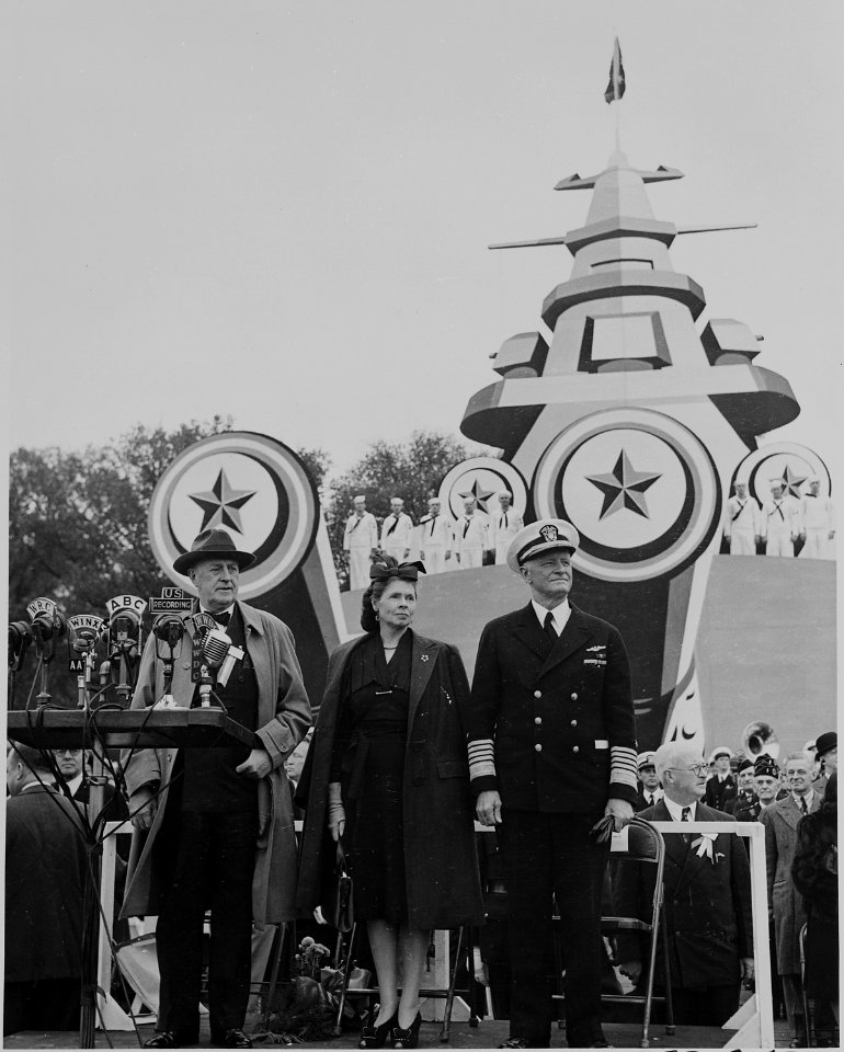 Photograph of Admiral Chester Nimitz, with Mrs. Nimitz and unidentified person, standing on speaker's platform during... - NARA - 199217