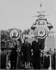 Photograph of Admiral Chester Nimitz, with Mrs. Nimitz and unidentified person, standing on speaker's platform during... - NARA - 199217