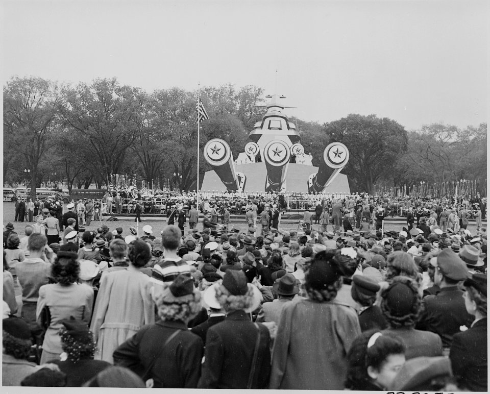 Photograph of battleship mock-up and crowds assembled for ceremony honoring Admiral Chester Nimitz. - NARA - 199209
