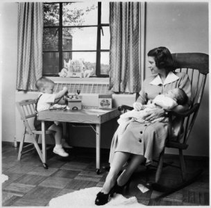 Photograph of Betty Ford Holding Infant Son, John Jack Ford, in her Arms while Michael Ford Plays at a Small Table... - NARA - 186876 photo