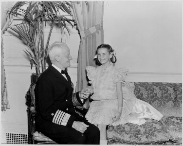 Photograph of Admiral Chester Nimitz shaking hands with actress Margaret O'Brien at a Roosevelt Birthday Ball... - NARA - 199320